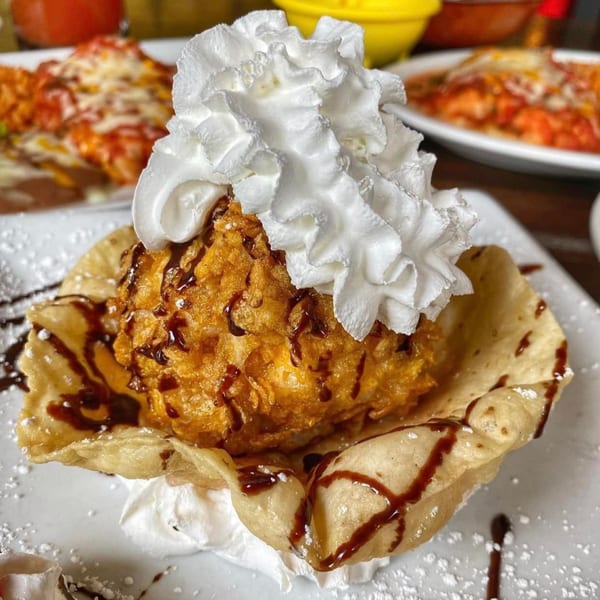 Sonrisa Grill's fried ice cream dessert, topped with whipped cream and chocolate syrup, served in a crispy shell.