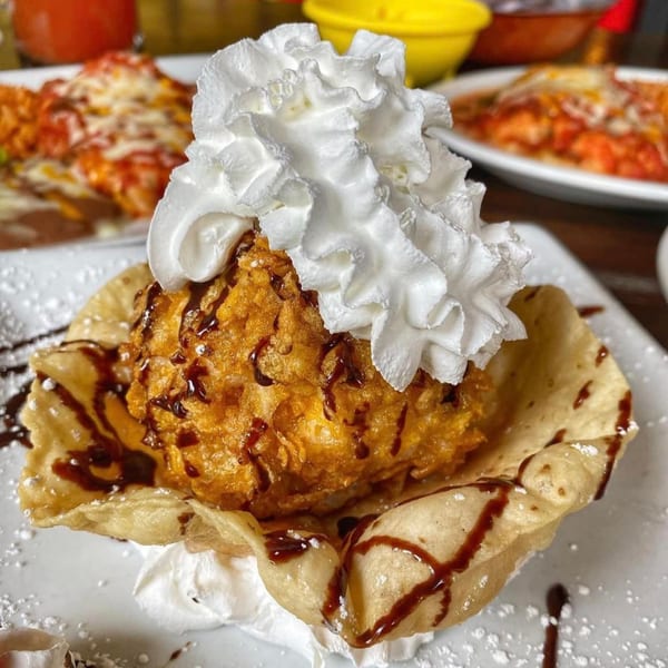 Golden-fried ice cream in a tortilla bowl, topped with whipped cream and chocolate syrup at Sonrisa Grill.